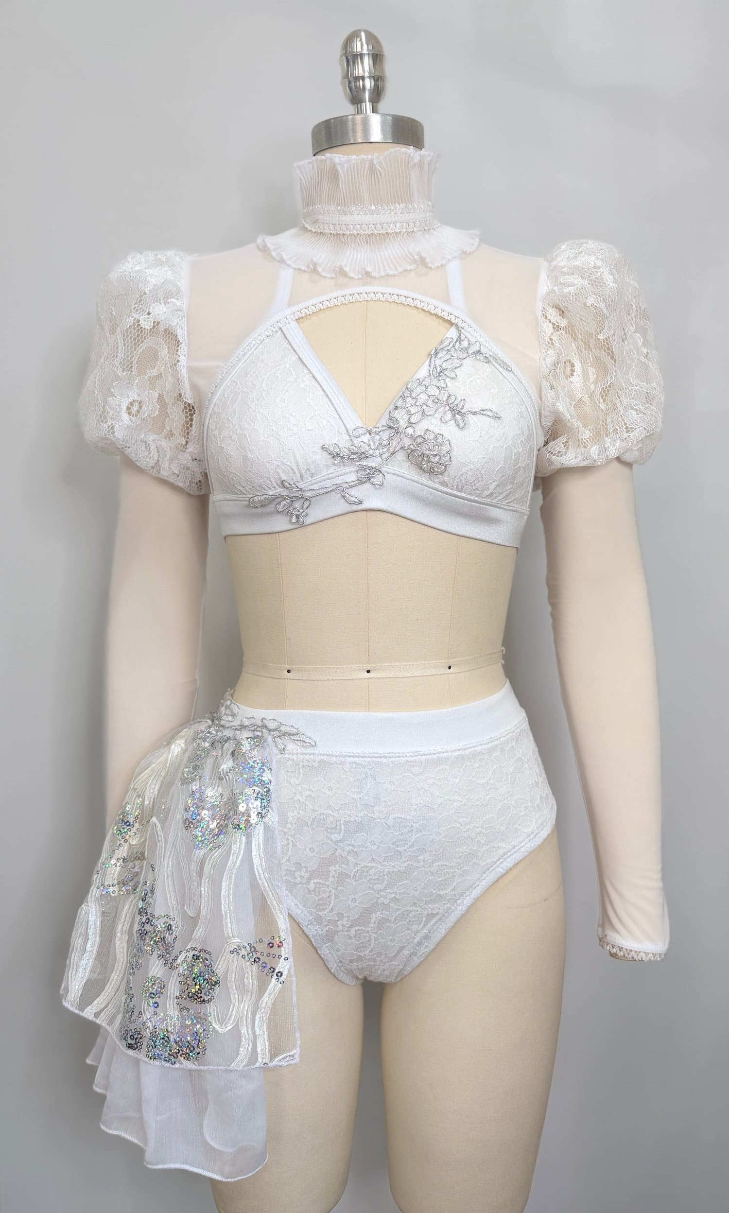 White competition costume with silver appliqué